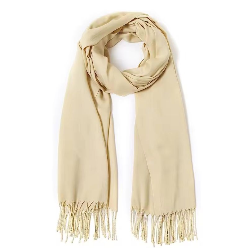 Beige scarf with fringes on a white background