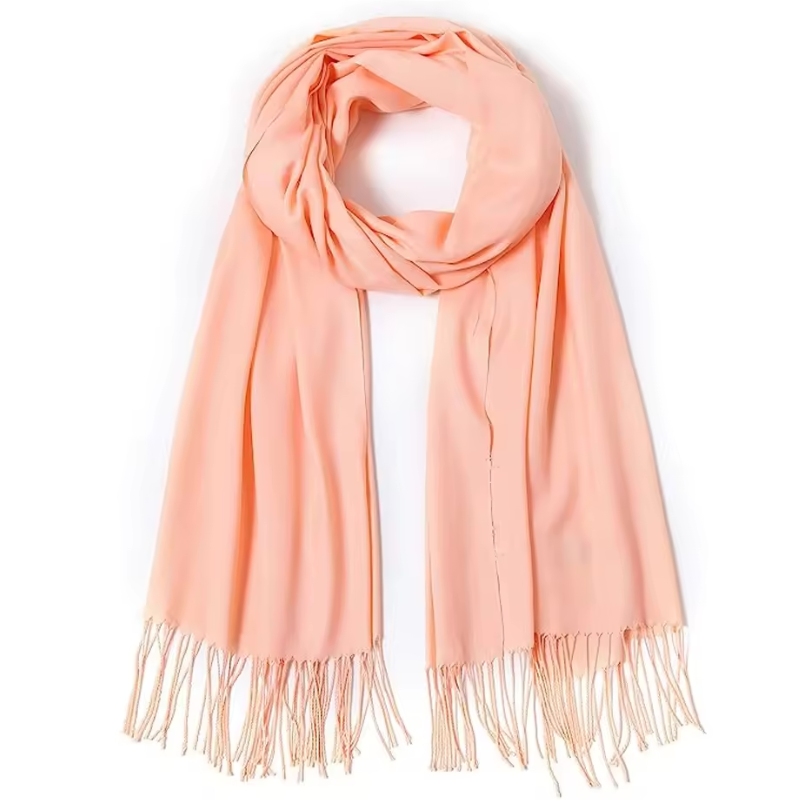 Peach-colored scarf with fringes on a white background