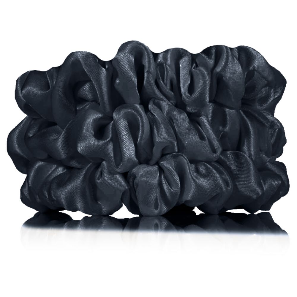 Set of black scrunchies on a white background