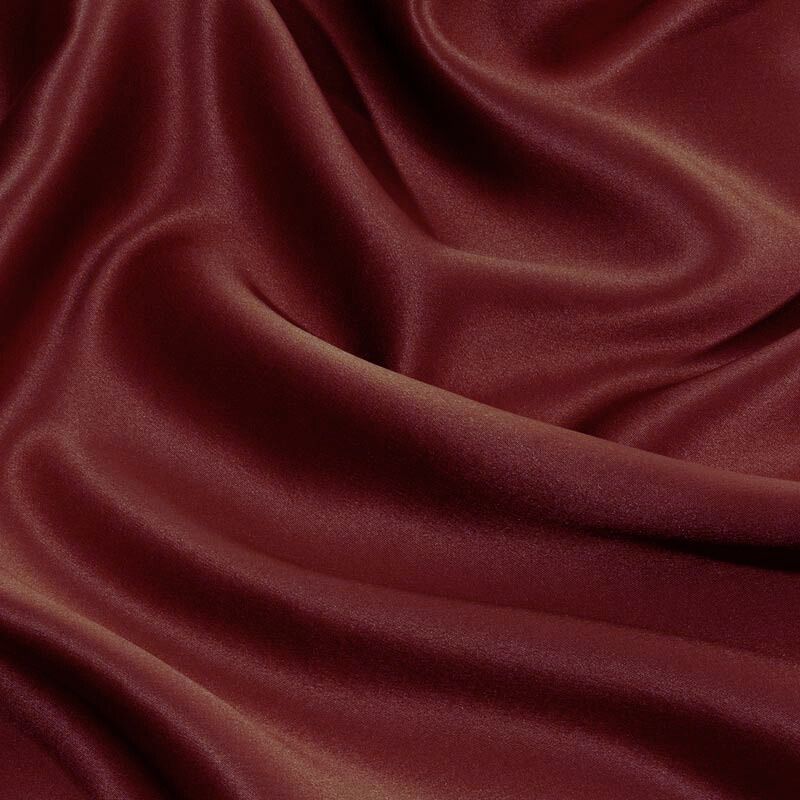 Close-up of dark red silk fabric with folds