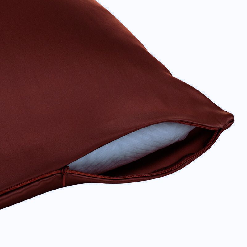 Close-up of a brown pillow with a white interior on a white background
