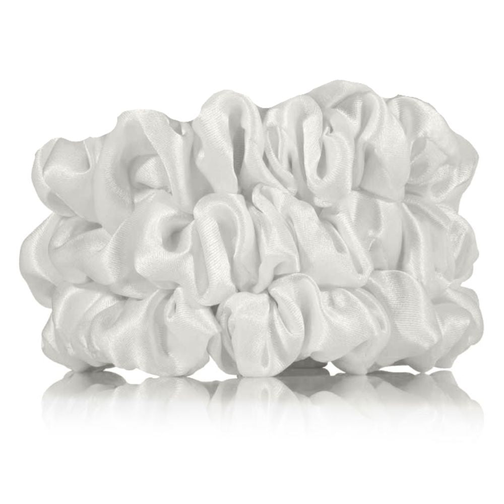 Three white scrunchies on a white background