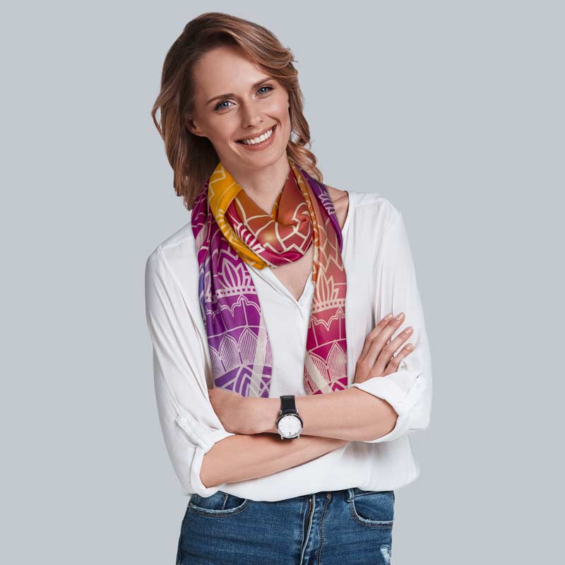 a woman wearing a mandala print scarf